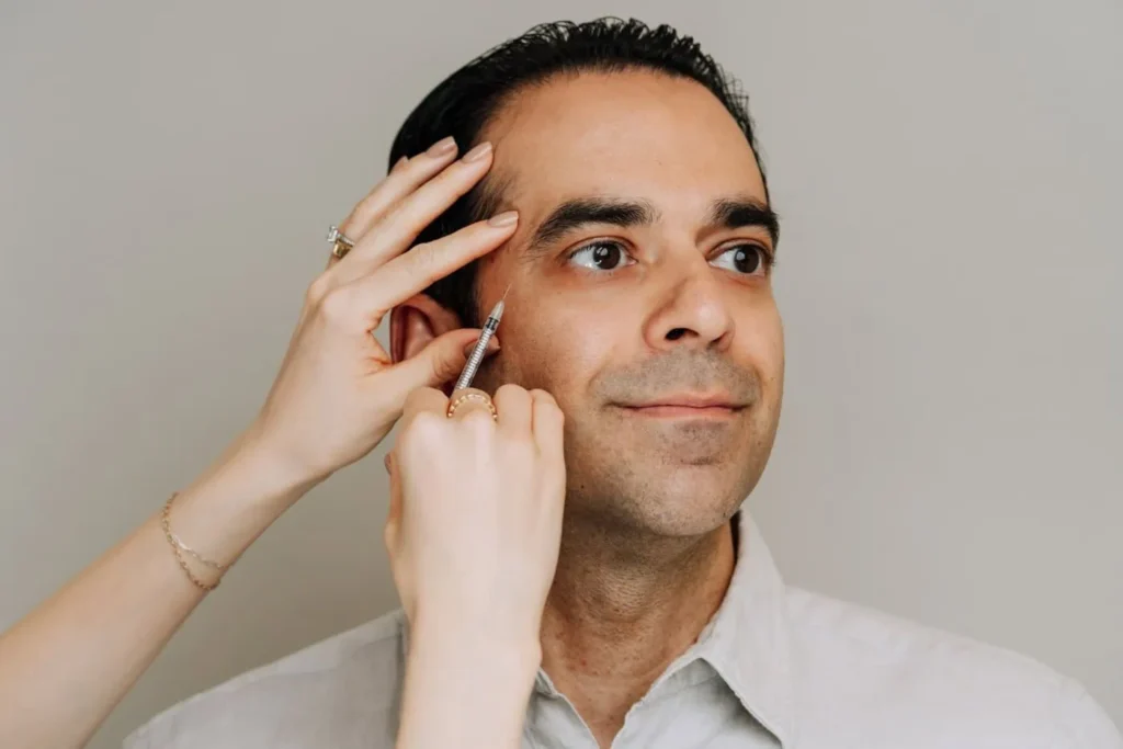 Man receiving facial fillers at Curated Medical