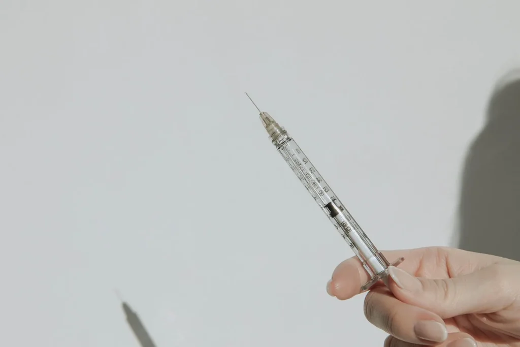 woman holding a needle for a semaglutide injection