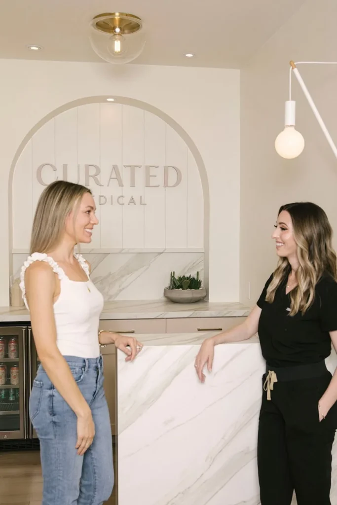 Two smiling women chatting about winter skincare treatments