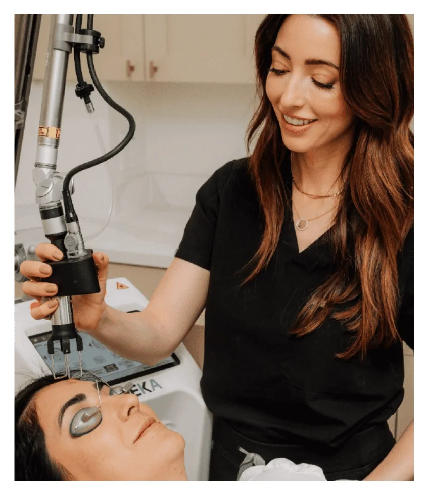 Katie performing a DEKA CO2 Laser treatment on a client