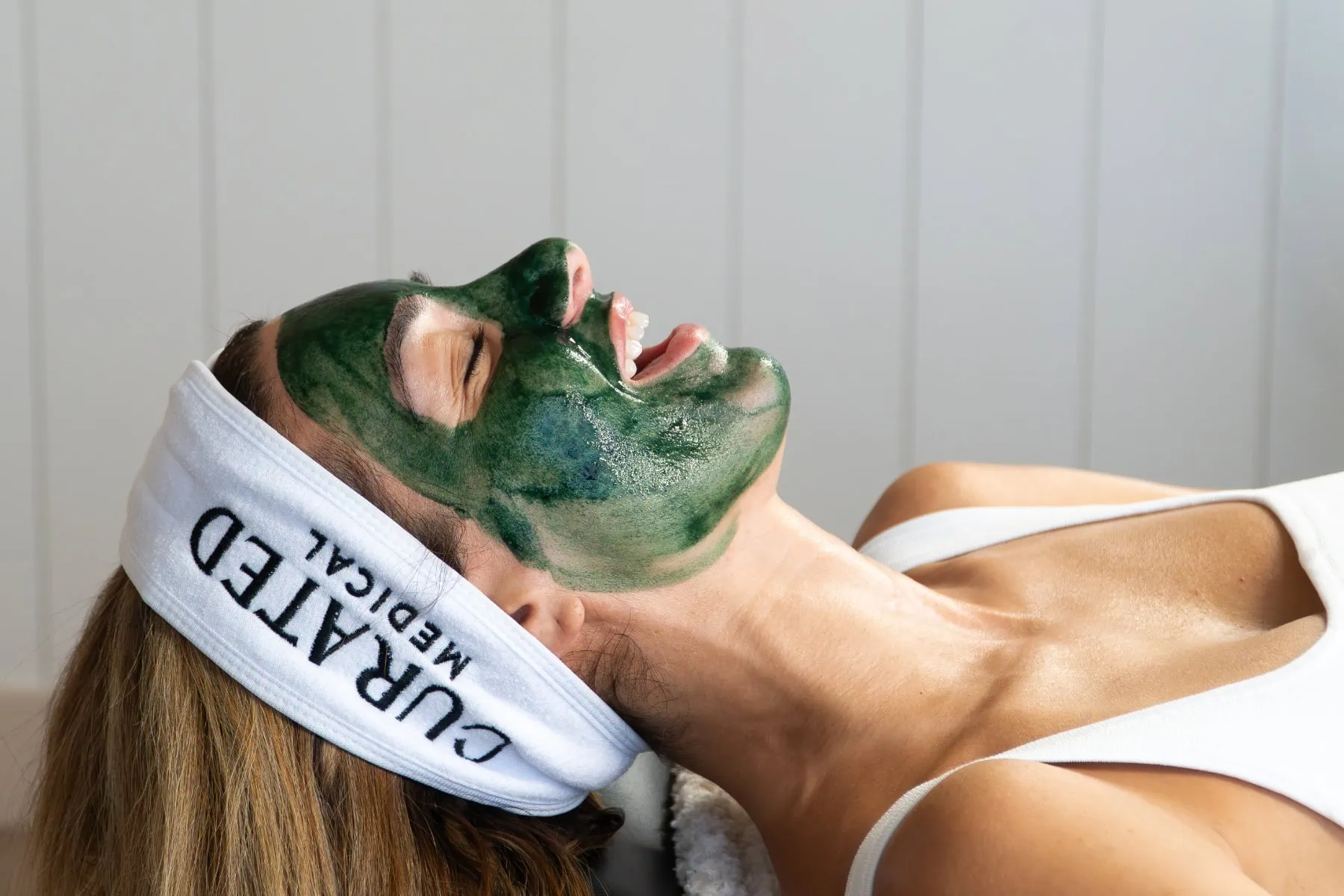 client at Curated Medical with Green Sea Peel on her face