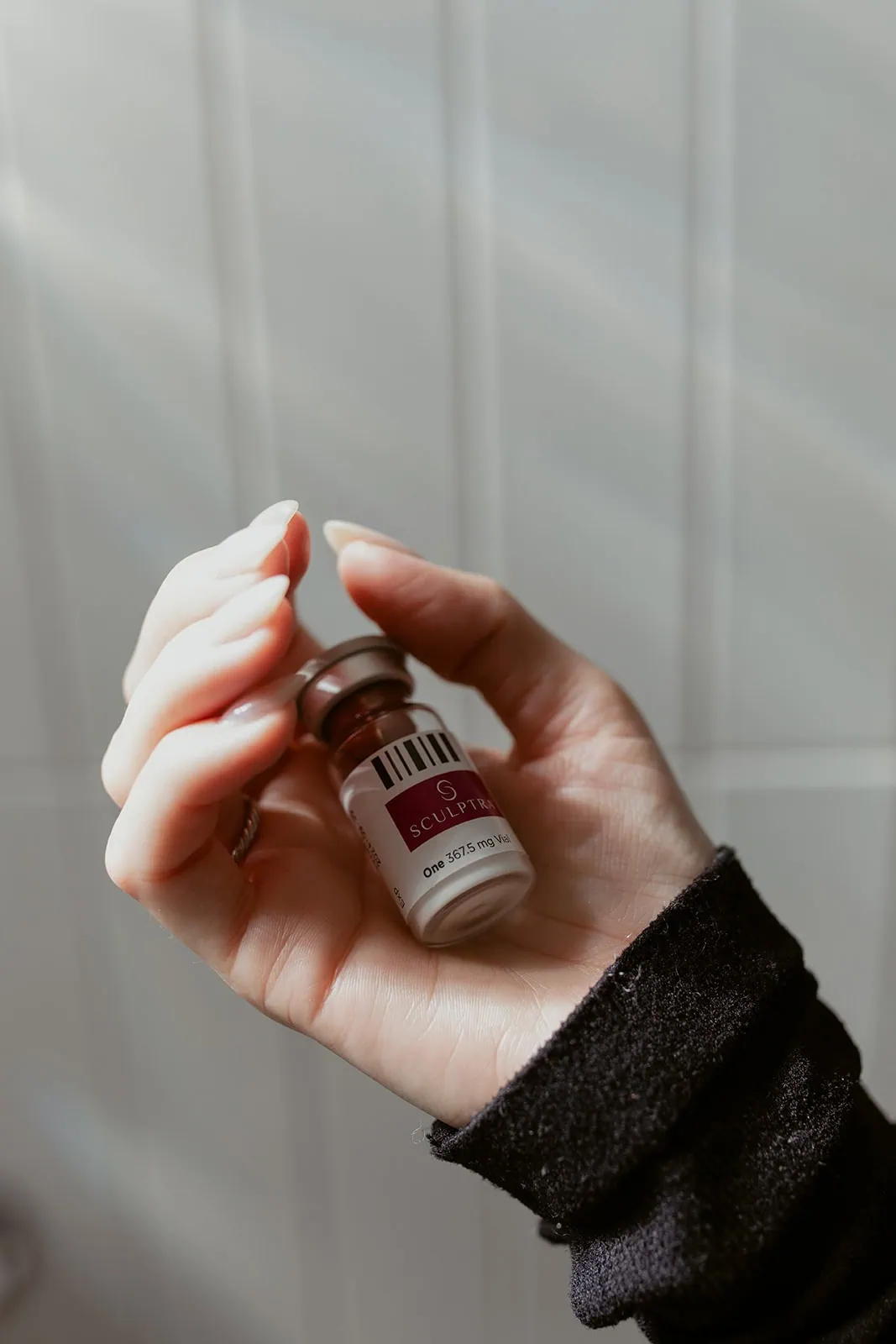 hand holding a Sculptra bottle