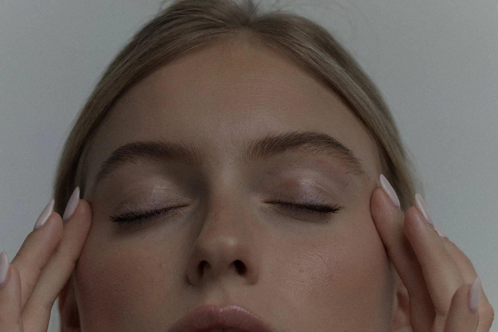 Close-up of woman showing crepey under eyes