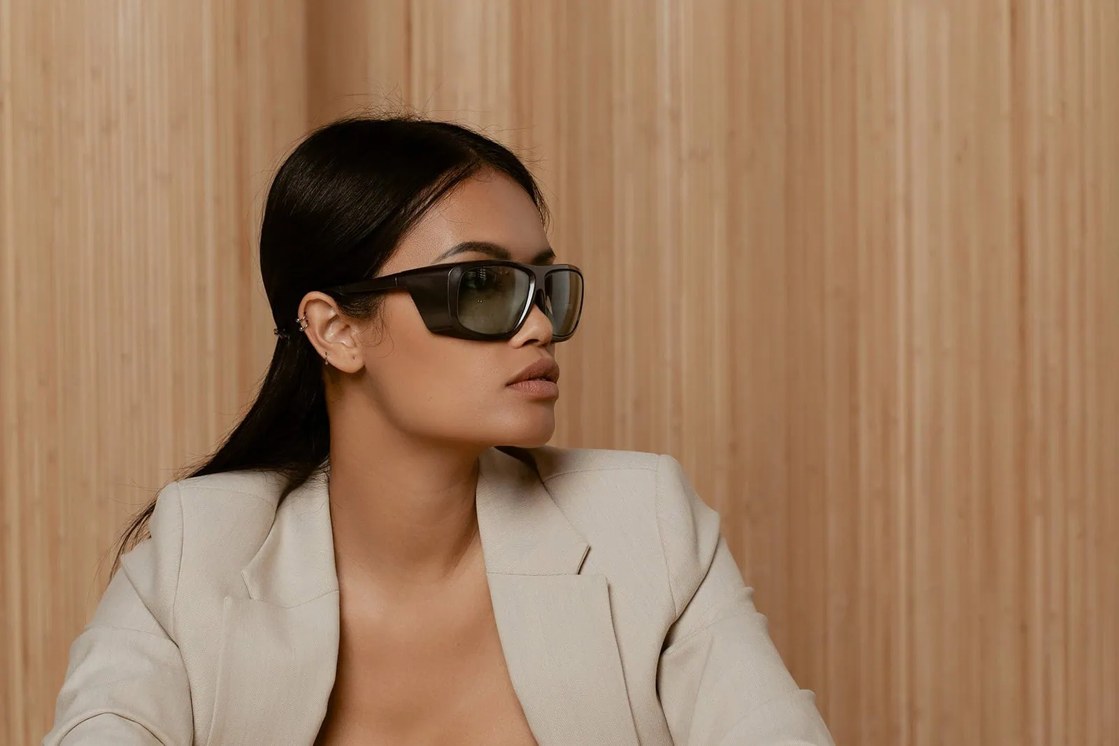 Woman wearing sunglasses showing early signs of aging on face