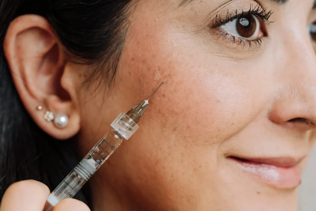 Woman receiving cheekbone injections for facial balancing in Scottsdale